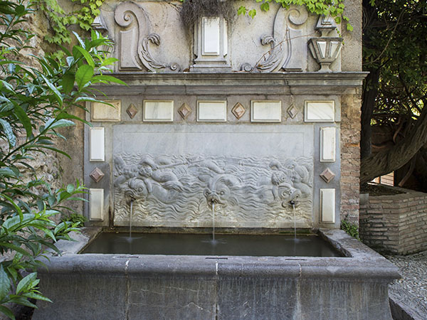 Fountain of the Dolphins in the Garden of Los Adarves, made in grey stone from the quarries of Sierra Elvira