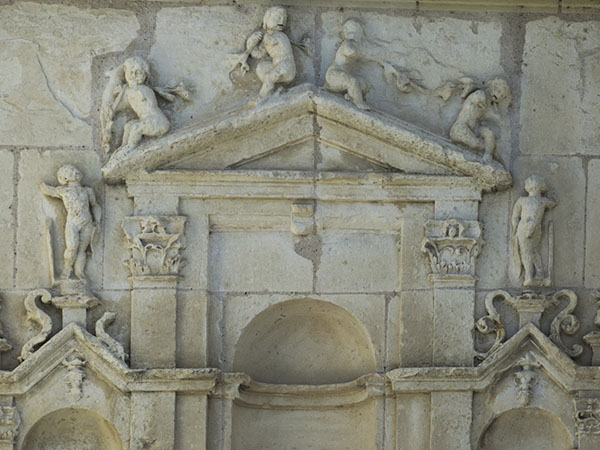 St. John the Baptist Collegiate Church, Montrésor, sculpted door decoration